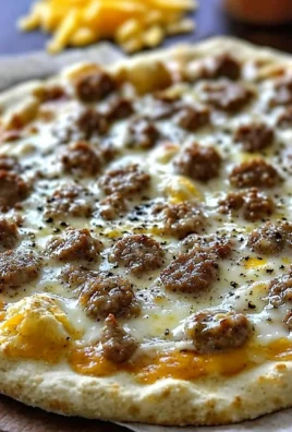 Sliced Biscuits and Sausage Gravy Breakfast Pizza on a wooden board