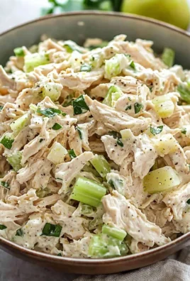 Delicious and colorful chicken salad served in a bowl with fresh ingredients.