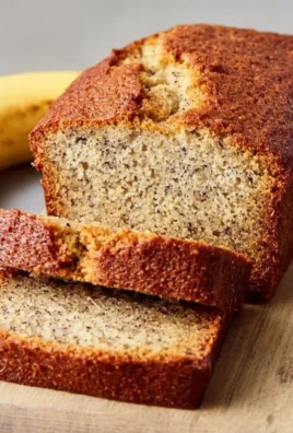 Sliced classic bread machine banana bread on a wooden cutting board