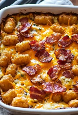Cracked out tater tot breakfast casserole topped with cheese and bacon