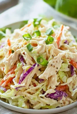 Creamy chicken coleslaw served in a bowl with fresh ingredients.