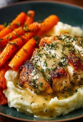 Creamy herb chicken with mashed potatoes and honey glazed carrots on a plate