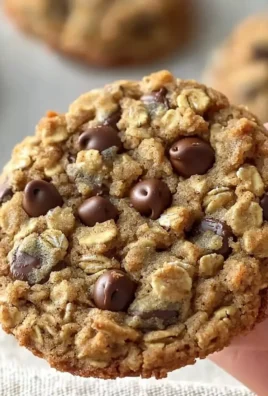 Delicious Crumbl oatmeal chocolate chip cookies on a baking sheet
