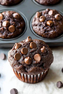 Freshly baked double chocolate muffins topped with chocolate chips