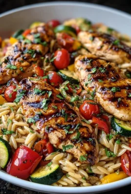 Plate of easy balsamic chicken served with veggie orzo.