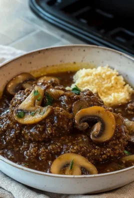 Delicious easy Salisbury steak served with gravy and mashed potatoes.