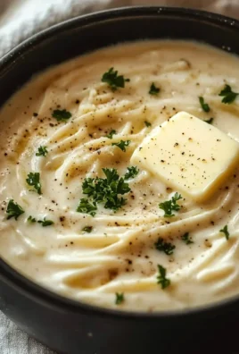 Bowl of creamy Garlic Parmesan Sauce with garlic and herbs