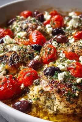Greek Chicken Bake with feta, olives, and tomatoes in a baking dish