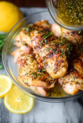 Grilled lemon garlic chicken thighs served with fresh herbs and lemon slices