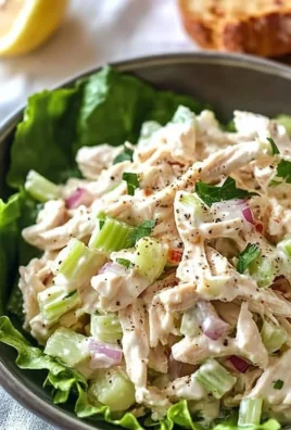 Bowl of healthy chicken salad with fresh vegetables and herbs