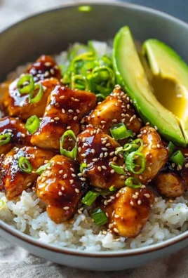 Delicious Hot Honey Chicken Bowl garnished with fresh vegetables and served in a bowl