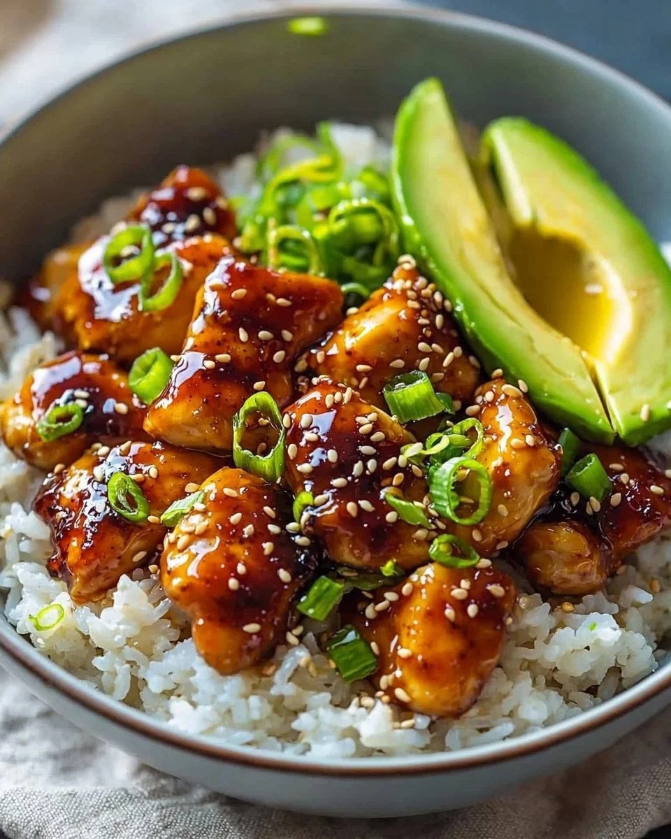 Delicious Hot Honey Chicken Bowl garnished with fresh vegetables and served in a bowl