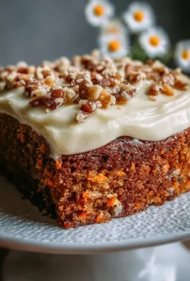 Moist homemade carrot cake with cream cheese frosting on a plate