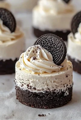 Delicious no-bake Oreo cheesecakes topped with crushed Oreo cookies.