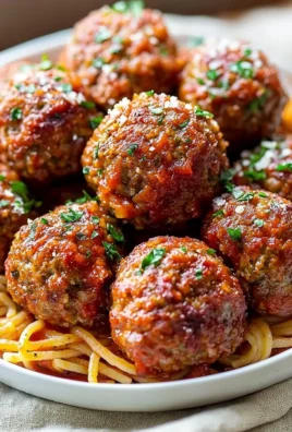 Delicious oven-baked Italian meatballs served with sauce and pasta