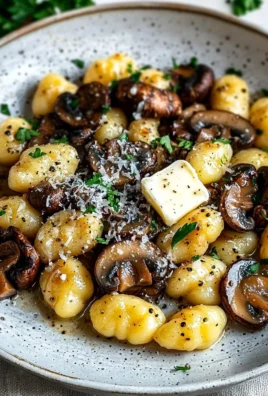 Pan-fried gnocchi with garlic butter mushrooms served in a skillet