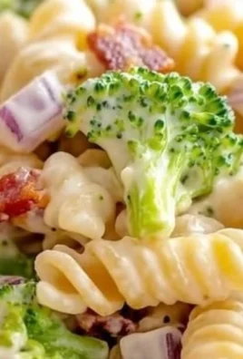 Delicious broccoli pasta salad in a bowl with colorful veggies and dressing.