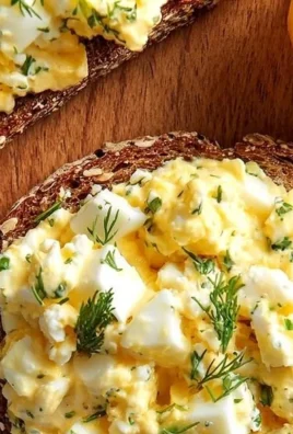Creamy cottage cheese egg salad sandwich garnished with fresh herbs
