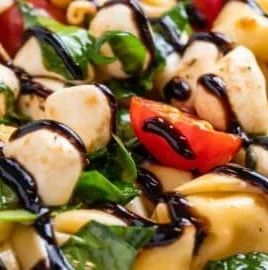 Caprese Tortellini Salad with fresh tomatoes, basil, and mozzarella cheese