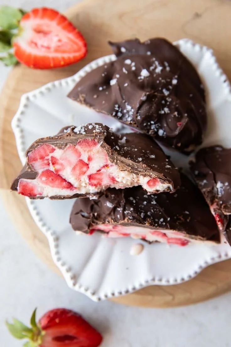 Delicious chocolate covered strawberry yogurt bites on a plate