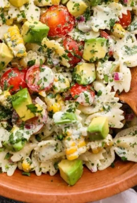 Colorful Cilantro Lime Pasta Salad with fresh ingredients in a white bowl