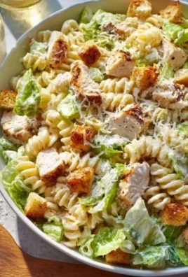 Creamy chicken pasta dish served in a bowl with herbs