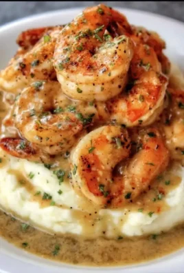 Creamy garlic shrimp served over creamy mashed potatoes in a delicious dish.