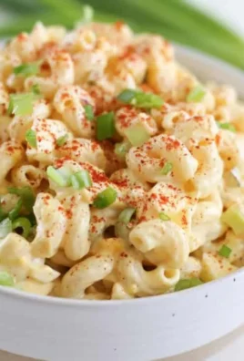 Delicious deviled egg pasta salad served in a bowl with fresh ingredients