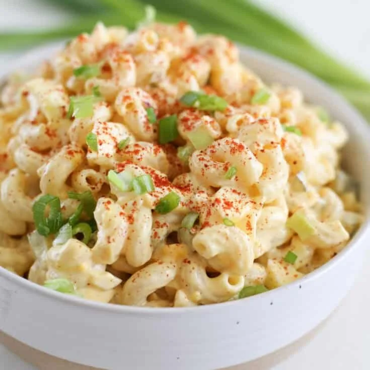 Delicious deviled egg pasta salad served in a bowl with fresh ingredients