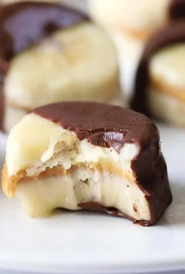 Frozen chocolate covered banana bites with peanut butter on a plate