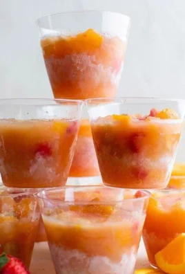 Colorful frozen fruit cups filled with a variety of berries and other fruits