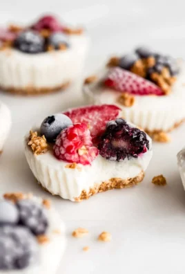 Frozen yogurt granola cups topped with fresh fruit and nuts