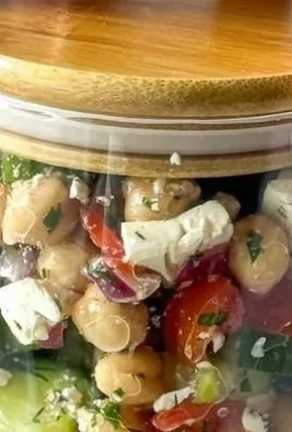 Delicious Greek chickpea salad with fresh vegetables and feta cheese