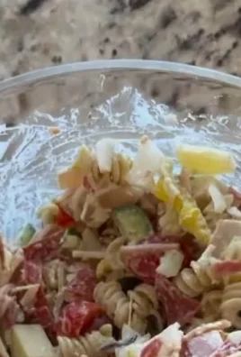 Colorful Grinder Pasta Salad with vegetables and dressing in a serving bowl