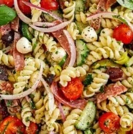 Bowl of colorful Italian pasta salad with vegetables and dressing