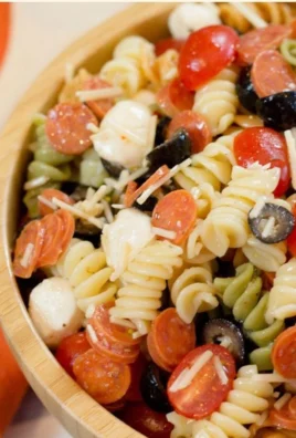 Colorful Italian Pasta Salad with fresh vegetables and dressing