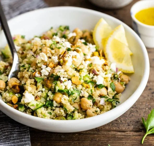 A colorful bowl of Jennifer Aniston Salad featuring fresh vegetables and quinoa.