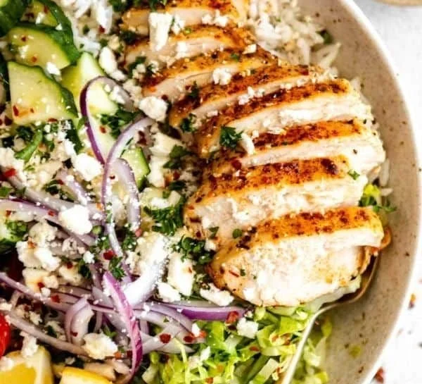 Delicious Lemon Herb Greek Chicken Bowl with fresh vegetables and herbs
