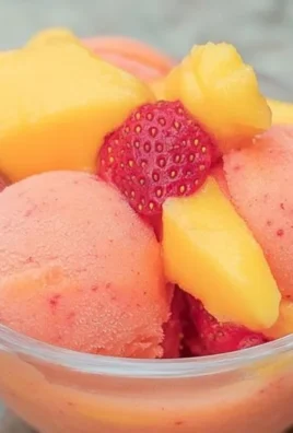 Bowl of Mango Strawberry Sorbet garnished with fresh fruit