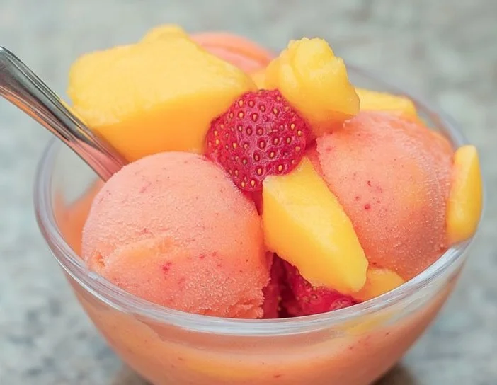 Bowl of Mango Strawberry Sorbet garnished with fresh fruit