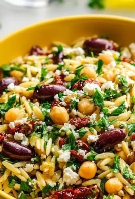 Mediterranean Chickpea and Orzo Salad with fresh vegetables and dressing