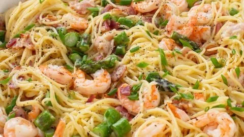 Creamy Shrimp Asparagus Carbonara garnished with parmesan and herbs