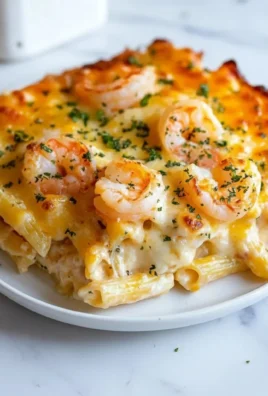 Delicious Shrimp Scampi Pasta Bake topped with cheese and garnished with parsley