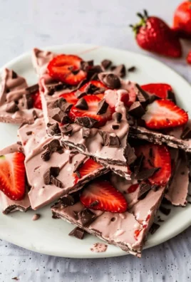 Delicious chocolate strawberry frozen yogurt bark on a marble surface