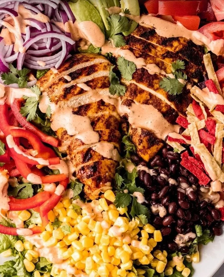 Bowl of Southwest Avocado Chicken Salad topped with colorful ingredients