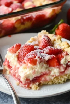 Delicious Strawberry Cheesecake Dump Cake topped with fresh strawberries.