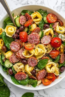 Colorful tortellini pasta salad with vegetables and dressing