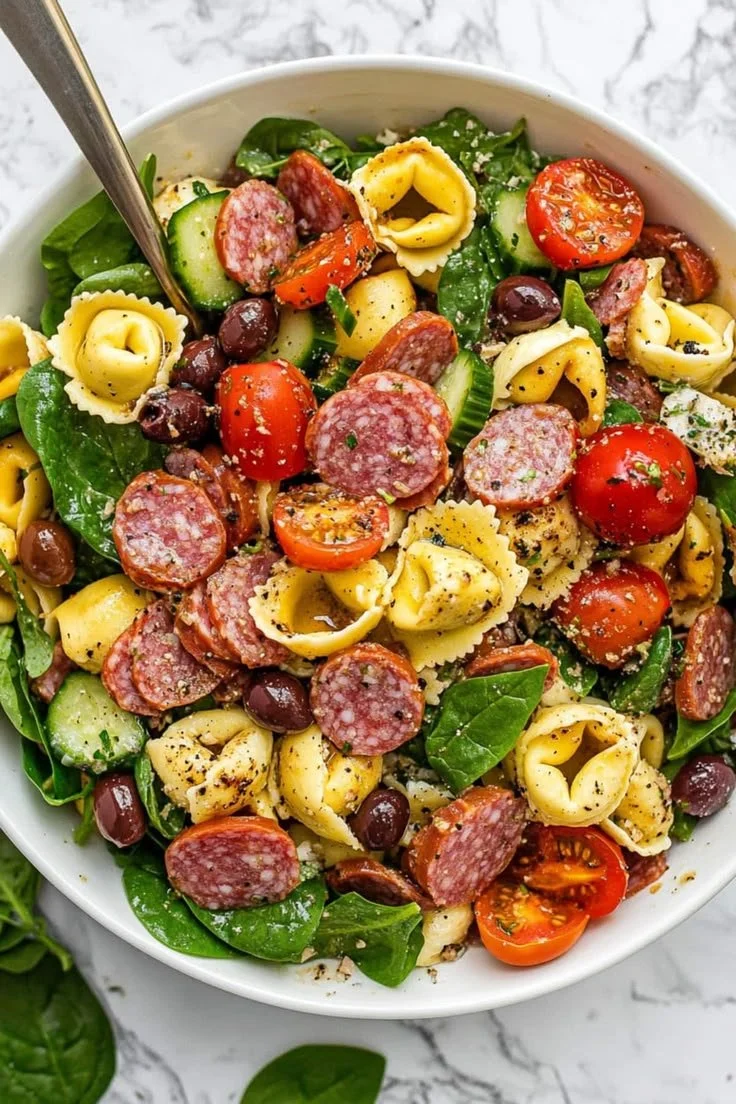 Colorful tortellini pasta salad with vegetables and dressing