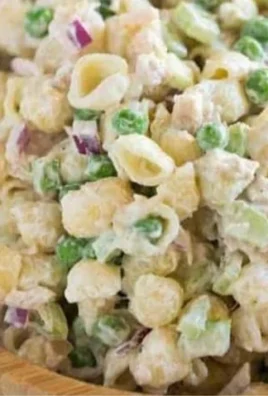 Bowl of Tuna Pasta Salad with fresh vegetables and herbs