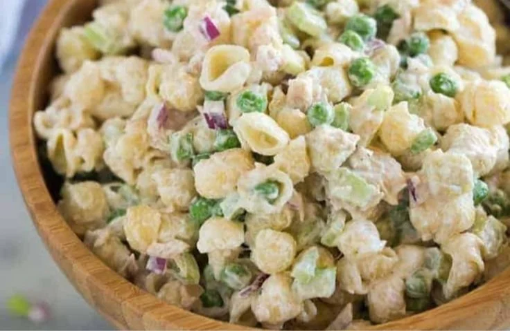 Bowl of Tuna Pasta Salad with fresh vegetables and herbs